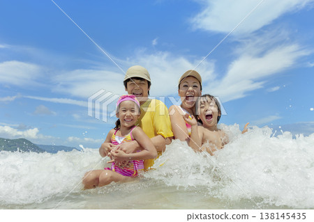 A family of four playing in the summer sea A family of four playing in the summer sea 138145435