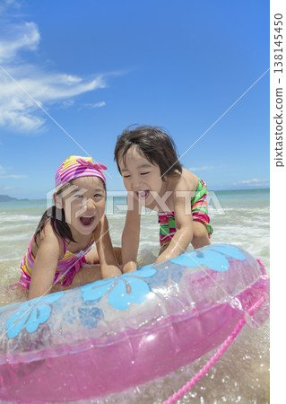 Sister and brother playing in the summer sea Sister and brother playing in the summer sea 138145450