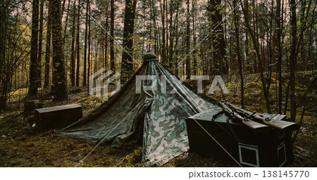 WWII German military camp with Zeltbahn tent and ammo crates in forest 138145770