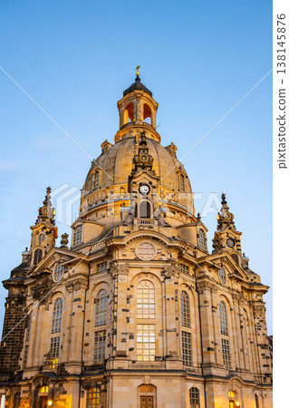 The Frauenkirche stands tall in Dresden, Germany, showcasing its large dome and intricate details. The scene highlights the church's architecture against a clear evening sky. The Frauenkirche stands tall in Dresden, Germany, showcasing its large dome and intricate details. The scene highlights the church's architecture against a clear evening sky. 138145876