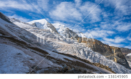 Piz Palu stands tall in the Swiss Alps, showcasing its impressive glacier and rocky formations under a brilliant blue sky. Adventure awaits in this stunning alpine landscape. Piz Palu stands tall in the Swiss Alps, showcasing its impressive glacier and rocky formations under a brilliant blue sky. Adventure awaits in this stunning alpine landscape. 138145905