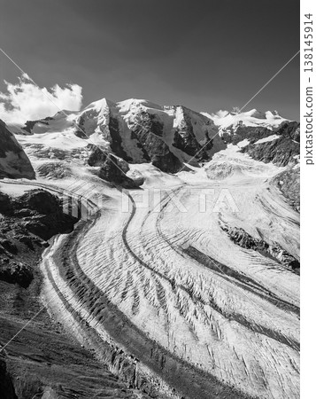 Piz Palu stands tall, surrounded by rocky ridges and the vast expanse of Pers Glacier. This breathtaking Swiss alpine scene captures the beauty of nature in the heart of the Alps. Piz Palu stands tall, surrounded by rocky ridges and the vast expanse of Pers Glacier. This breathtaking Swiss alpine scene captures the beauty of nature in the heart of the Alps. 138145914