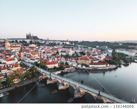 Morning light bathes Prague in warmth, highlighting the beautiful architecture along the Vltava River. The Charles Bridge connects historical features, creating a picturesque panorama of the city. Morning light bathes Prague in warmth, highlighting the beautiful architecture along the Vltava River. The Charles Bridge connects historical features, creating a picturesque panorama of the city. 138146008