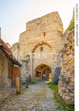 Rabi Castle gate stands tall as visitors approach. The large stone structure shows the history of Bohemia. The path leads to a rich past full of stories and past lives. 138146033