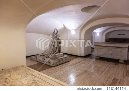 Visitors can see the tombs of Pius VI in the crypt of St. Peters Basilica. The area includes a statue of the Pope and several ornate tombs. The setting is quiet and historic. 138146154