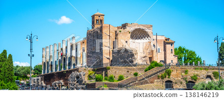 Tourists walk around the Temple of Venus and Roma, located in the east part of the Roman Forum. This site shows the remains of ancient architecture and historic pillars. Tourists walk around the Temple of Venus and Roma, located in the east part of the Roman Forum. This site shows the remains of ancient architecture and historic pillars. 138146219