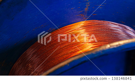 Copper wire coils inside a blue container in a working industrial environment Copper wire coils inside a blue container in a working industrial environment 138146841