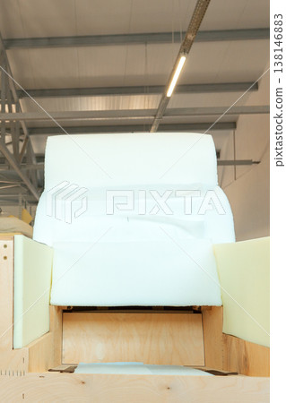 Chair in a workshop under bright lights with a simple design and raw materials showing Chair in a workshop under bright lights with a simple design and raw materials showing 138146883