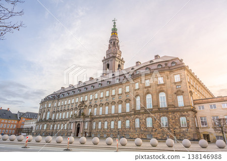 Visitors walk around Christiansborg Palace in Copenhagen, Denmark. The palace serves as a government building and is located on the Slotsholmen islet. Many people admire the historic architecture. 138146988