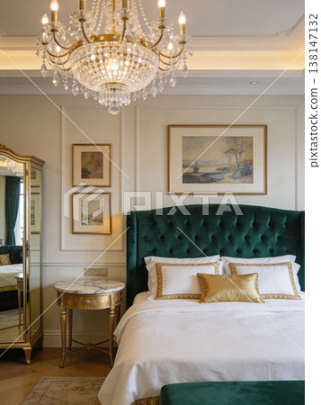 Luxurious Master Bedroom Interior Design with Elegant Emerald Green Velvet Tufted Headboard, Ornate Crystal Chandelier, and Sophisticated Gold Accents 138147132