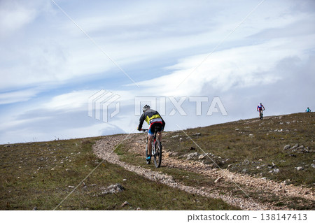 Mountain bikers riding on gravel trail Mountain bikers riding on gravel trail 138147413