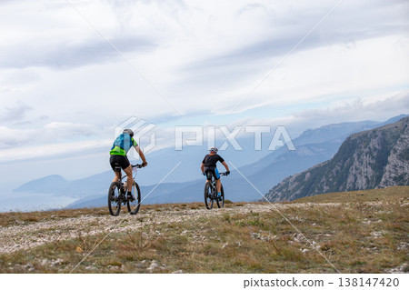 Two mountain bikers riding on rocky terrain Two mountain bikers riding on rocky terrain 138147420