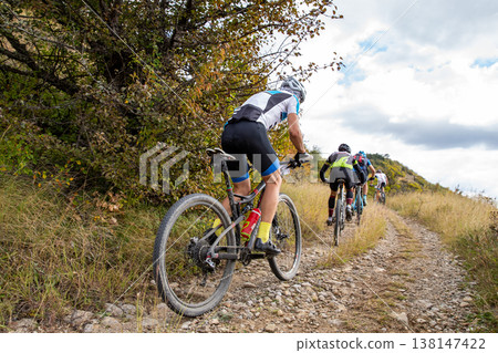 Group mountain bikers racing 138147422