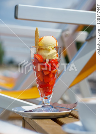 Fresh strawberries with ice cream in a glass, summer dessert, sweet food, refreshing treat and lifestyle concept in summer beach cafe Fresh strawberries with ice cream in a glass, summer dessert, sweet food, refreshing treat and lifestyle concept in summer beach cafe 138147447