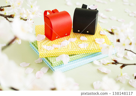Cherry blossom petals and a school bag – a bright image of spring filled with hope. Cherry blossom petals and a school bag – a bright image of spring filled with hope. 138148117