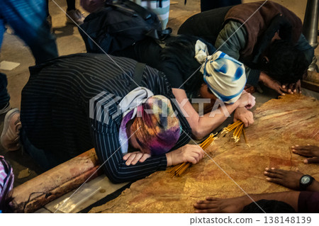 Christian pilgrims on the Stone of Anointing, Holy Sepulchre in Jerusalem. 138148139