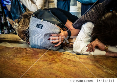 Christian pilgrims on the Stone of Anointing, Holy Sepulchre in Jerusalem. 138148151