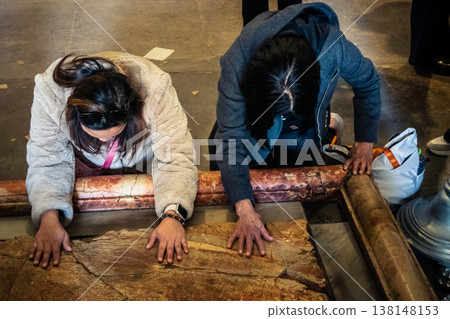 Christian pilgrims on the Stone of Anointing, Holy Sepulchre in Jerusalem. Christian pilgrims on the Stone of Anointing, Holy Sepulchre in Jerusalem. 138148153