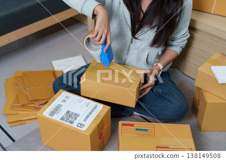 Woman preparing packages for shipping at home Woman preparing packages for shipping at home 138149508