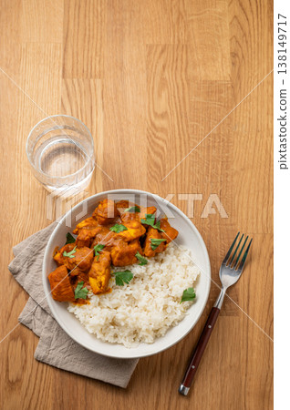 Chicken tikka masala curry with rice on wooden background Chicken tikka masala curry with rice on wooden background 138149717