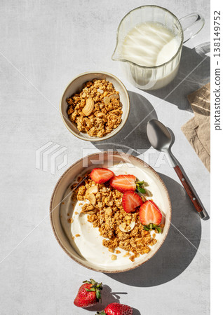 Balanced breakfast with yogurt, granola and strawberry on light background. Top view 138149752