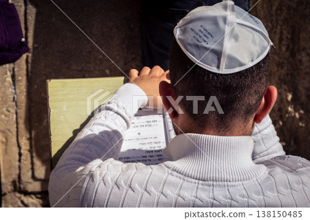 Men studying religious texts at the Western Wall, Jerusalem Men studying religious texts at the Western Wall, Jerusalem 138150485