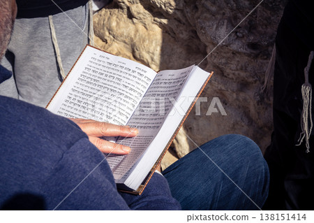Men studying religious texts at the Western Wall, Jerusalem Men studying religious texts at the Western Wall, Jerusalem 138151414