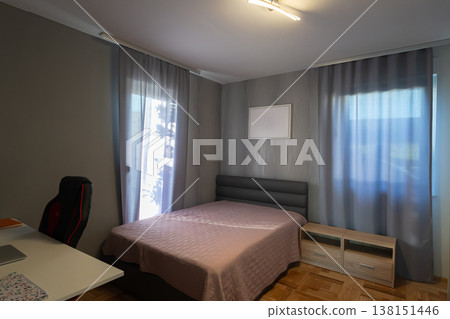 Modular house bedroom interior with smart vacuum cleaner and warm sunset light over modern bed Modular house bedroom interior with smart vacuum cleaner and warm sunset light over modern bed 138151446
