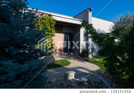 Modular house exterior entrance with smart home features, automatic vacuum and warm sunset light Modular house exterior entrance with smart home features, automatic vacuum and warm sunset light 138151458