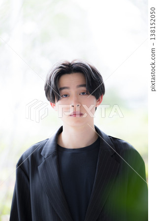 A natural portrait of a young, trustworthy businessman in his 20s, with a refreshing and serious expression. A natural portrait of a young, trustworthy businessman in his 20s, with a refreshing and serious expression. 138152050