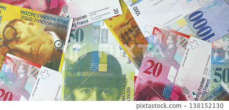 Swiss franc banknotes. The current francs money bills lies on table in big amount. The concept of business and investment in Switzerland Swiss franc banknotes. The current francs money bills lies on table in big amount. The concept of business and investment in Switzerland 138152130