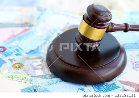 Bahraini dinar currency money bills and wooden judge mallet close up. The concept of judgment or auction Bahraini dinar currency money bills and wooden judge mallet close up. The concept of judgment or auction 138152131