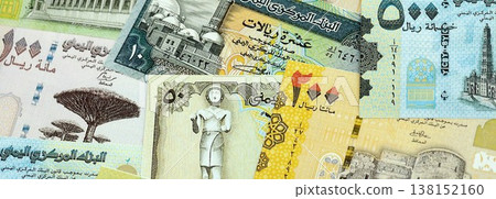 Yemeni rial paper banknotes pile on table. Yemen YER currency money bills in big amount. Concept of economics, taxation and banking in Yemen Yemeni rial paper banknotes pile on table. Yemen YER currency money bills in big amount. Concept of economics, taxation and banking in Yemen 138152160