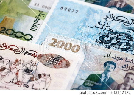 Algerian dinar paper banknotes pile on table. Algeria DZD currency money bills in big amount. Concept of economics, taxation and banking in Algeria Algerian dinar paper banknotes pile on table. Algeria DZD currency money bills in big amount. Concept of economics, taxation and banking in Algeria 138152172