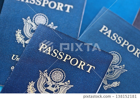 Many US passports on table close up. Official identification document books for citizens of United States. Concept of travel and tourism Many US passports on table close up. Official identification document books for citizens of United States. Concept of travel and tourism 138152181