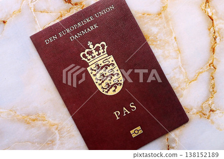 Danish passport on table close up. Official identification document book for citizens of Denmark. Concept of travel and tourism Danish passport on table close up. Official identification document book for citizens of Denmark. Concept of travel and tourism 138152189
