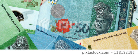 Malaysian ringgit paper banknotes pile on table. Malaysia MYR currency money bills in big amount. Concept of economics, taxation and banking in Malaysia Malaysian ringgit paper banknotes pile on table. Malaysia MYR currency money bills in big amount. Concept of economics, taxation and banking in Malaysia 138152195