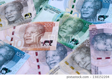 South African rand paper banknotes pile on table. South Africa ZAR currency money bills in big amount. Concept of economics, taxation and banking in South Africa South African rand paper banknotes pile on table. South Africa ZAR currency money bills in big amount. Concept of economics, taxation and banking in South Africa 138152204
