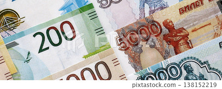 Russian ruble paper banknotes pile on table. Russia RUB currency money bills in big amount. Concept of economics, taxation and banking in Russia Russian ruble paper banknotes pile on table. Russia RUB currency money bills in big amount. Concept of economics, taxation and banking in Russia 138152219