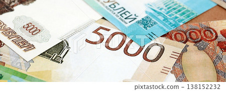 Russian ruble paper banknotes pile on table. Russia RUB currency money bills in big amount. Concept of economics, taxation and banking in Russia Russian ruble paper banknotes pile on table. Russia RUB currency money bills in big amount. Concept of economics, taxation and banking in Russia 138152232
