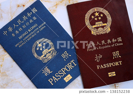 Chinese and Hong Kong passport on table close up. Official identification document book for citizens of China. Concept of travel and tourism 138152238