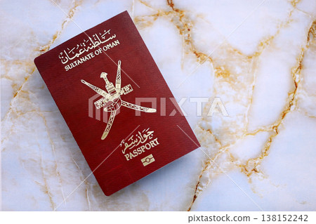 Omani passport on table close up. Official identification document book for citizens of Oman. Concept of travel and tourism 138152242
