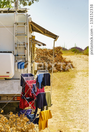 Clothes hanging to dry outdoors by camping car. Caravan vacation. 138152338