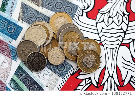 Banknotes of Polish zloty and grosz coins currency on polish flag. Poland PLN money close up. Business, economy and finance concept Banknotes of Polish zloty and grosz coins currency on polish flag. Poland PLN money close up. Business, economy and finance concept 138152771