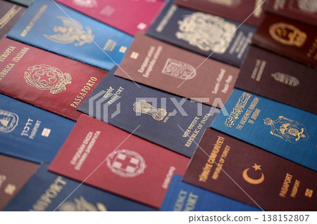 Big amount of passports of various different countries. Covers of expired passports close up. Travel documents for tourism Big amount of passports of various different countries. Covers of expired passports close up. Travel documents for tourism 138152807
