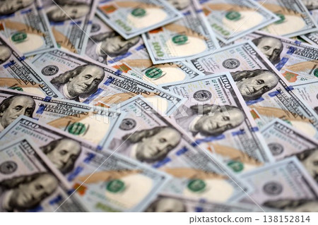 Stacks of hundred dollar bills showcase intricate designs on a flat surface. Money background with Franklin on the 100-dollar note 138152814