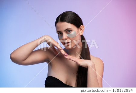 Young woman applying under eye patches for skin care routine, pampering facial treatment, self-care concept, beauty products, and anti-aging skincare Young woman applying under eye patches for skin care routine, pampering facial treatment, self-care concept, beauty products, and anti-aging skincare 138152854