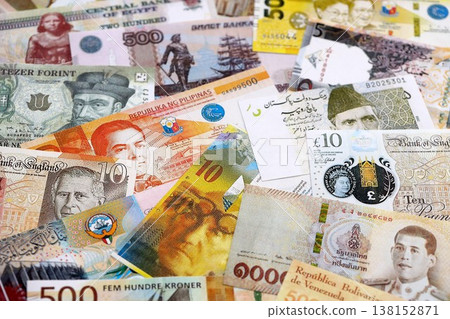 Various currencies money bills banknotes in yellow and orange color. Many cash bills from different countries in big pile close up. World economy and currency exchange concept Various currencies money bills banknotes in yellow and orange color. Many cash bills from different countries in big pile close up. World economy and currency exchange concept 138152871