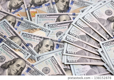 Stack of dollars and cash with a money background. US money and banknotes. Pile of 100 USD bills. American hundred-dollar notes. Pattern of money. Cash and credit theme 138152878