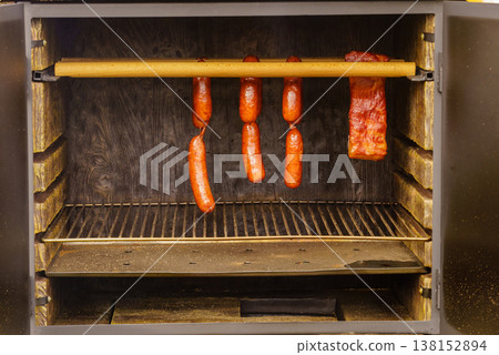 Smoked sausages meat hanging in smokehouse Smoked sausages meat hanging in smokehouse 138152894